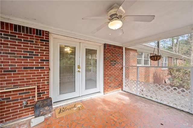 unfurnished sunroom featuring ceiling fan and french doors