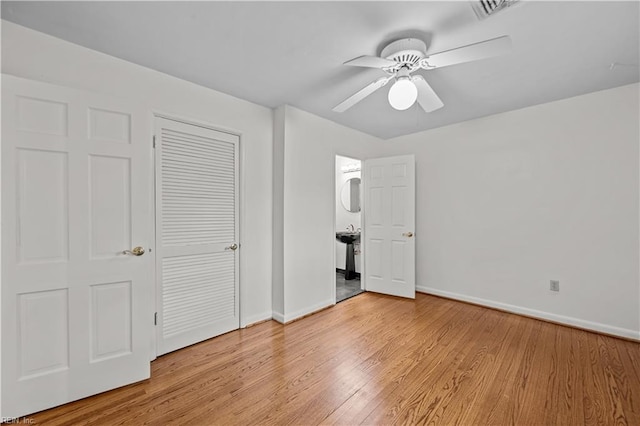 unfurnished bedroom with ceiling fan, a closet, and light wood-type flooring