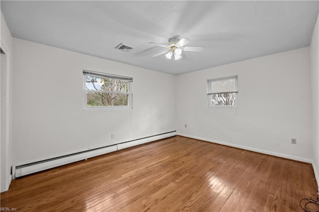 empty room featuring ceiling fan, a baseboard radiator, and wood-type flooring