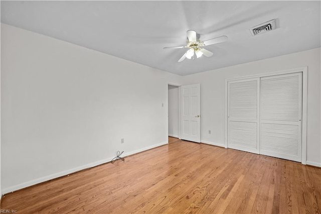 unfurnished bedroom with ceiling fan, a closet, and light hardwood / wood-style flooring