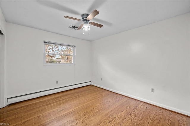 empty room with ceiling fan, light hardwood / wood-style flooring, and a baseboard radiator