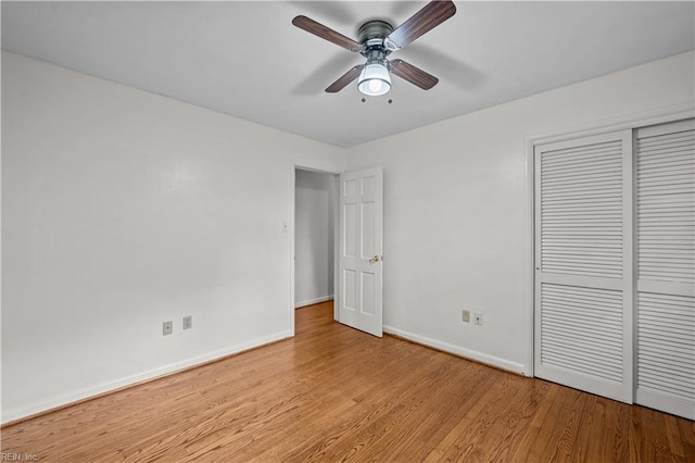 unfurnished bedroom featuring ceiling fan, a closet, and light hardwood / wood-style floors