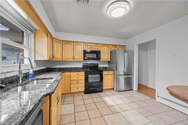 kitchen featuring a baseboard heating unit, light tile patterned flooring, sink, and black appliances