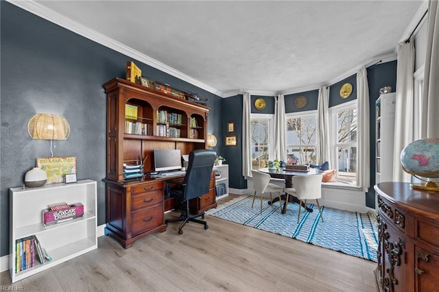 home office with light hardwood / wood-style floors and crown molding