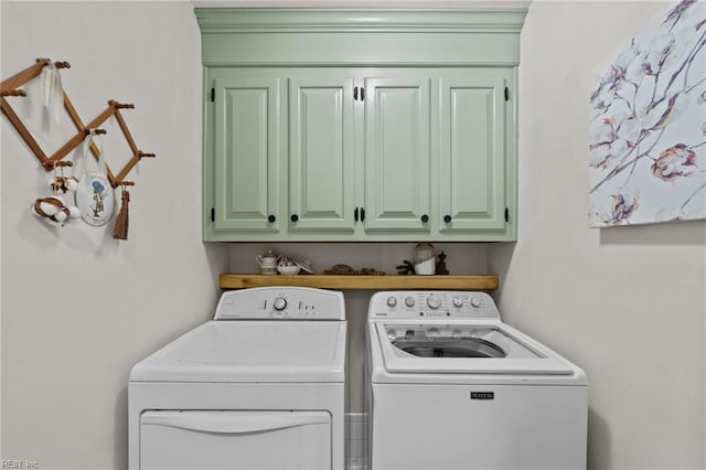 laundry room with cabinets and washer and clothes dryer