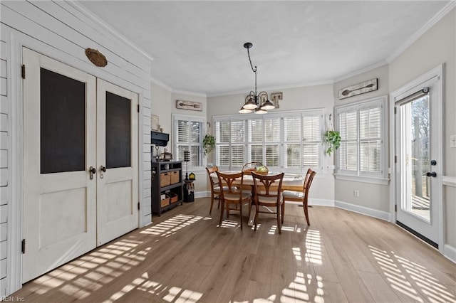 sunroom with french doors and an inviting chandelier