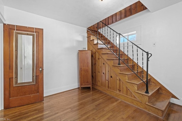 stairs featuring hardwood / wood-style flooring