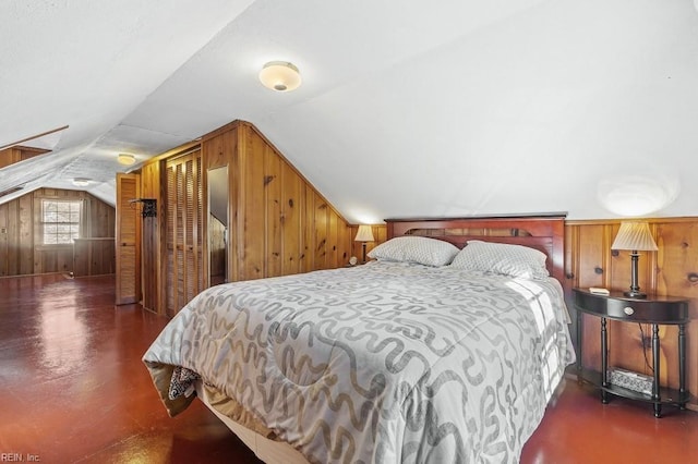 bedroom featuring wooden walls and vaulted ceiling