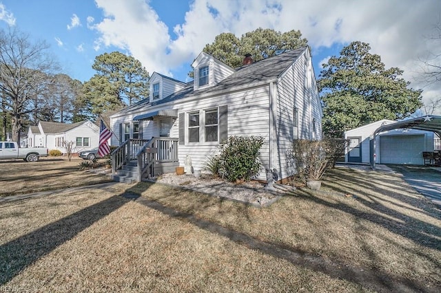 cape cod-style house featuring a front yard and a carport