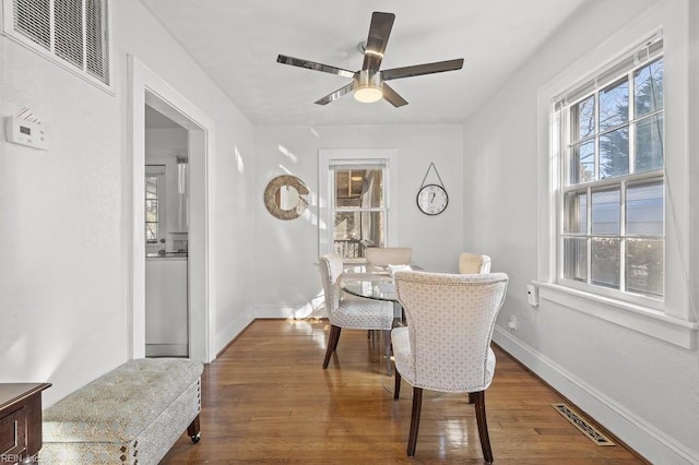 dining area featuring ceiling fan and dark hardwood / wood-style floors