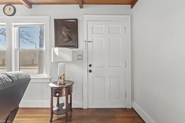 entrance foyer with beamed ceiling and dark hardwood / wood-style floors