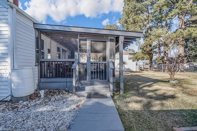 doorway to property with a yard