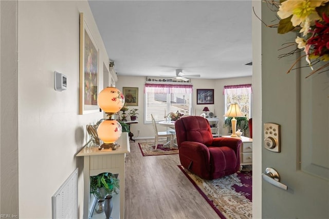 living room with ceiling fan and wood-type flooring