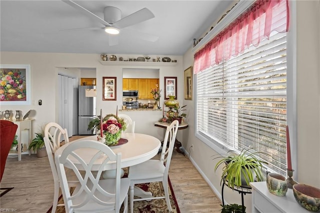 dining room featuring ceiling fan and light hardwood / wood-style flooring