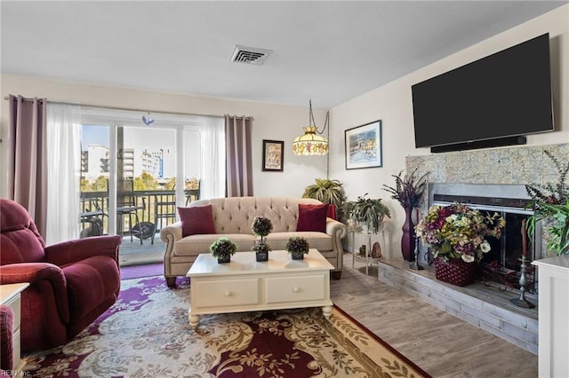 living room featuring a fireplace and light hardwood / wood-style flooring