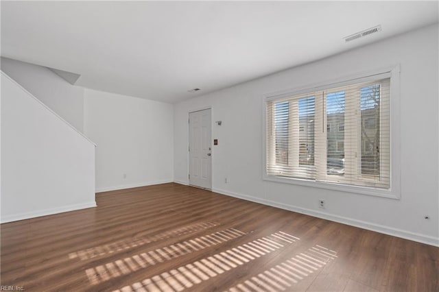 interior space with visible vents, baseboards, and wood finished floors