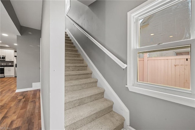 stairs featuring wood-type flooring