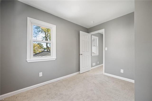 unfurnished room with light colored carpet