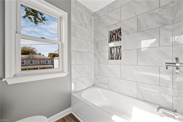 bathroom featuring tiled shower / bath