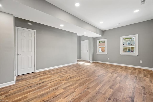 unfurnished room with light wood-type flooring