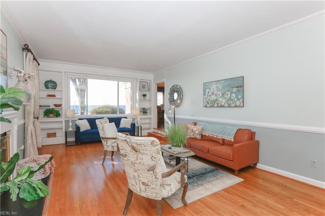 living room featuring built in shelves, ornamental molding, and hardwood / wood-style flooring