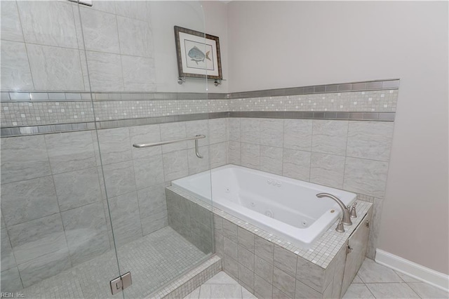 bathroom with tile patterned floors and shower with separate bathtub