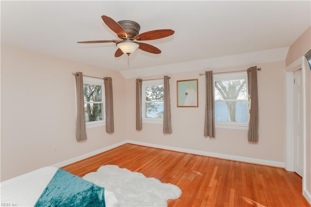 unfurnished bedroom with ceiling fan and light wood-type flooring