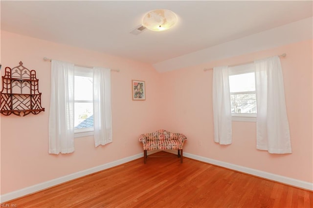 interior space with vaulted ceiling and hardwood / wood-style flooring