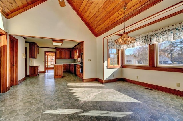 unfurnished living room with ceiling fan with notable chandelier, high vaulted ceiling, wooden ceiling, and plenty of natural light