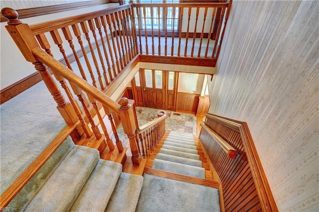 staircase with a towering ceiling