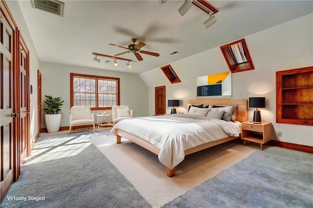 bedroom with ceiling fan, light carpet, lofted ceiling, and rail lighting