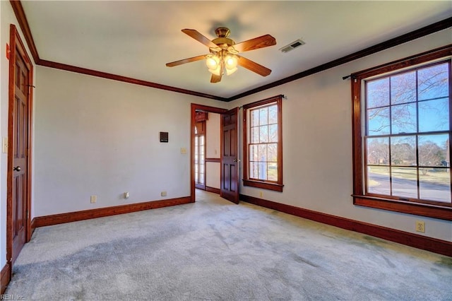 carpeted empty room with ceiling fan and ornamental molding