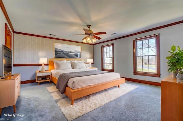 bedroom featuring ornamental molding, ceiling fan, and light carpet