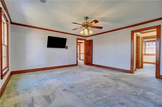 carpeted empty room featuring ceiling fan and ornamental molding