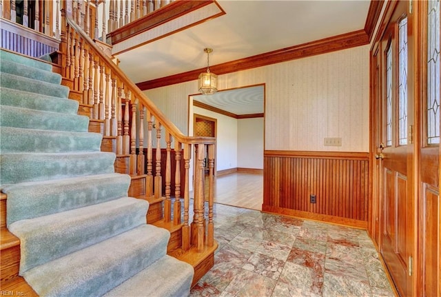 stairway featuring ornamental molding