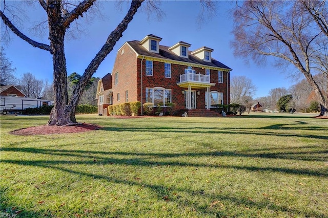 colonial-style house with a front yard and a balcony