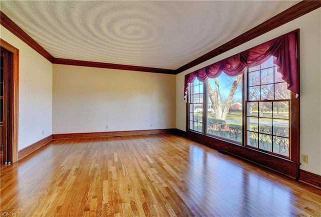 unfurnished room with light wood-type flooring and crown molding