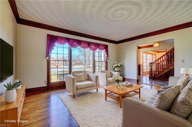 living room with wood-type flooring and ornamental molding