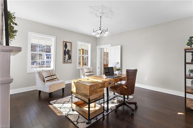 office space with an inviting chandelier and dark hardwood / wood-style flooring