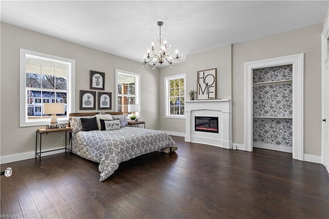 bedroom with dark hardwood / wood-style flooring and a chandelier