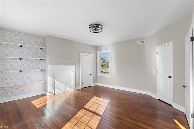 unfurnished room featuring dark wood-type flooring