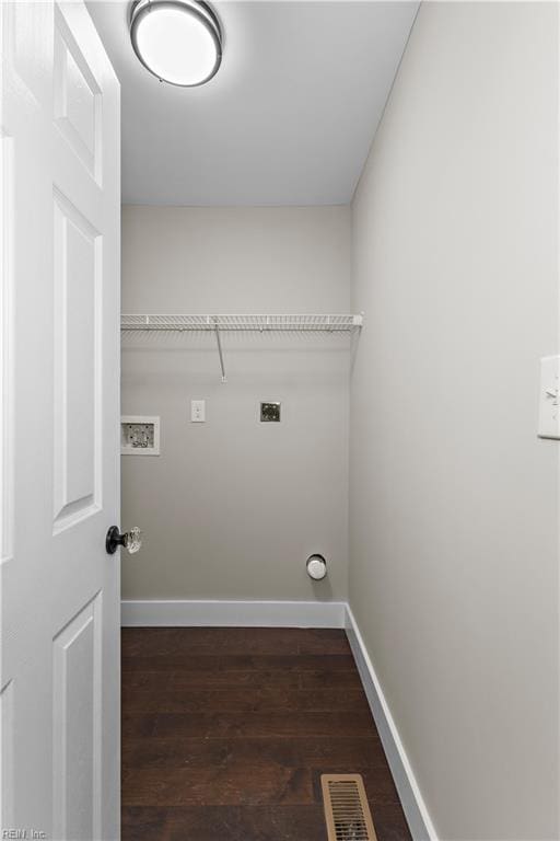 clothes washing area featuring hookup for an electric dryer and dark hardwood / wood-style flooring