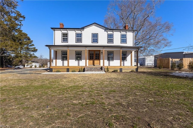 view of front of house with a porch and a front yard