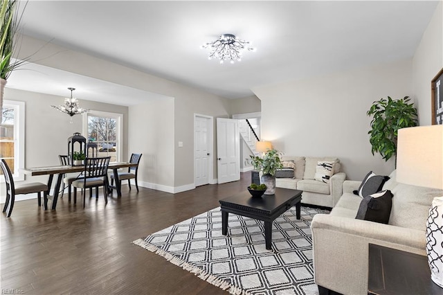 living room featuring dark hardwood / wood-style flooring and a chandelier