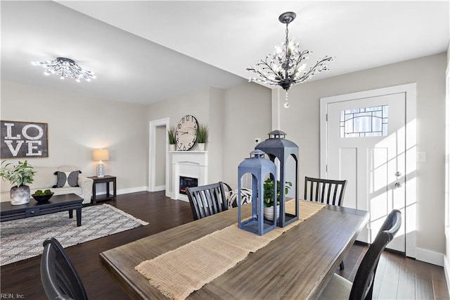 dining space featuring a notable chandelier and dark wood-type flooring