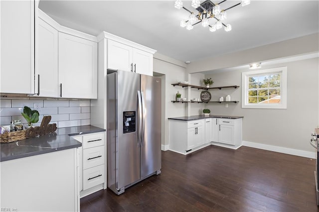 kitchen with dark hardwood / wood-style flooring, stainless steel fridge, tasteful backsplash, and white cabinetry