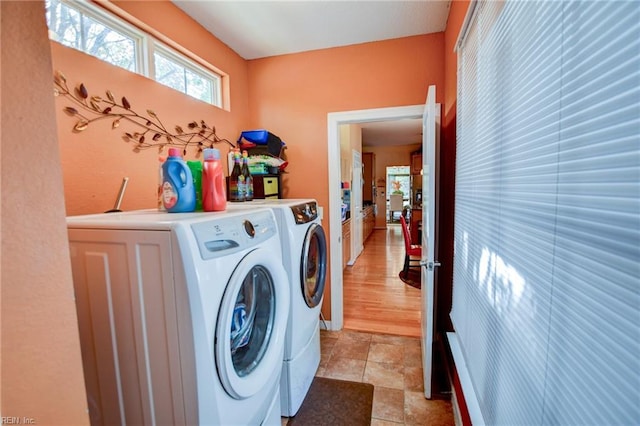 clothes washing area featuring washing machine and clothes dryer and light tile patterned floors