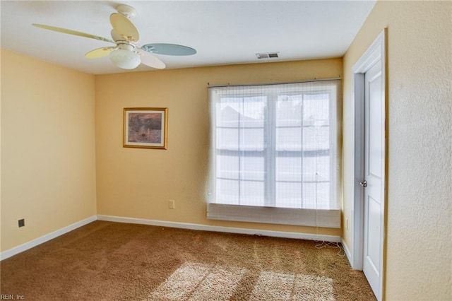 spare room featuring carpet floors and ceiling fan