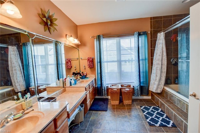 bathroom featuring vanity and tiled shower / bath