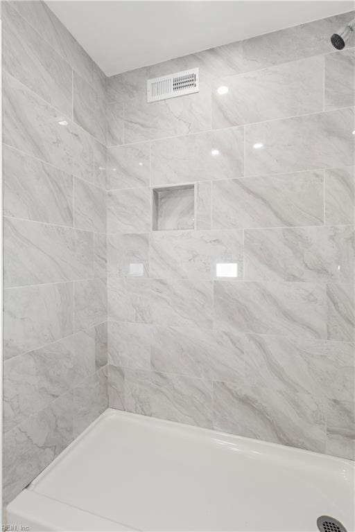 bathroom with a tile shower